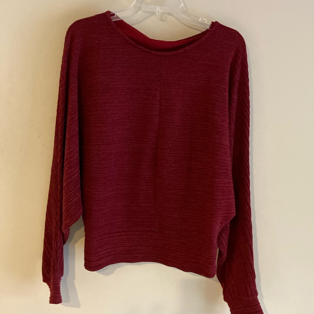 Gorgeous crimson see through back detail elevated top.